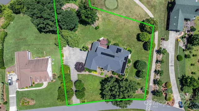 a view of a swimming pool is in front of a house
