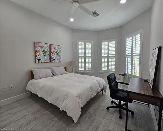 a bedroom with a bed and a desk