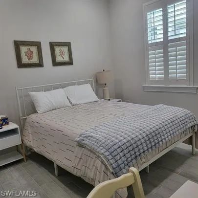 a bedroom with bed and a window