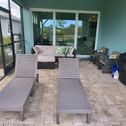 a balcony with furniture and a potted plant