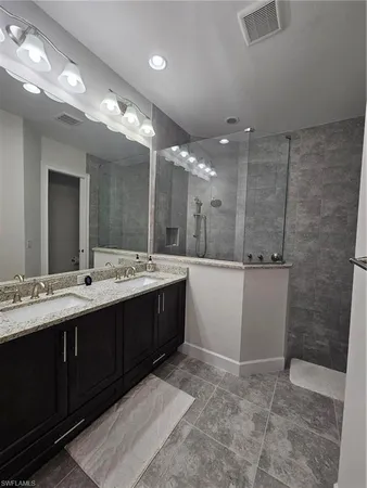 a bathroom with a sink double vanity and a mirror
