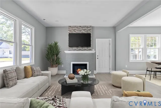 a living room with furniture fireplace and window
