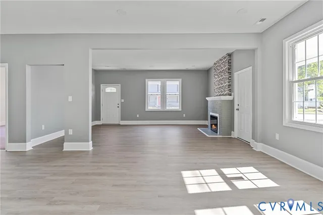 a view of a big room with windows and chandelier in a room