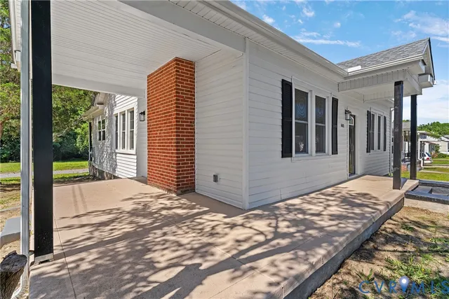 a view of backyard and floor to ceiling window