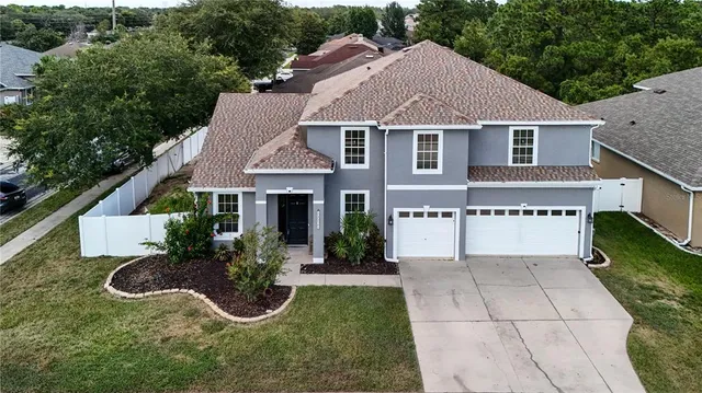 a aerial view of a house with yard and a garden