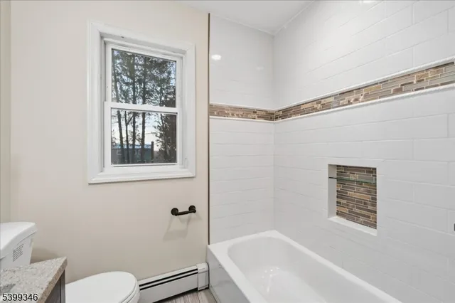 a bathroom with a toilet and a bathtub