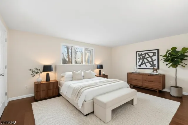 a bedroom with a bed a couch and a potted plant