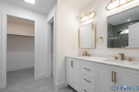 a bathroom with a double vanity sink mirror and