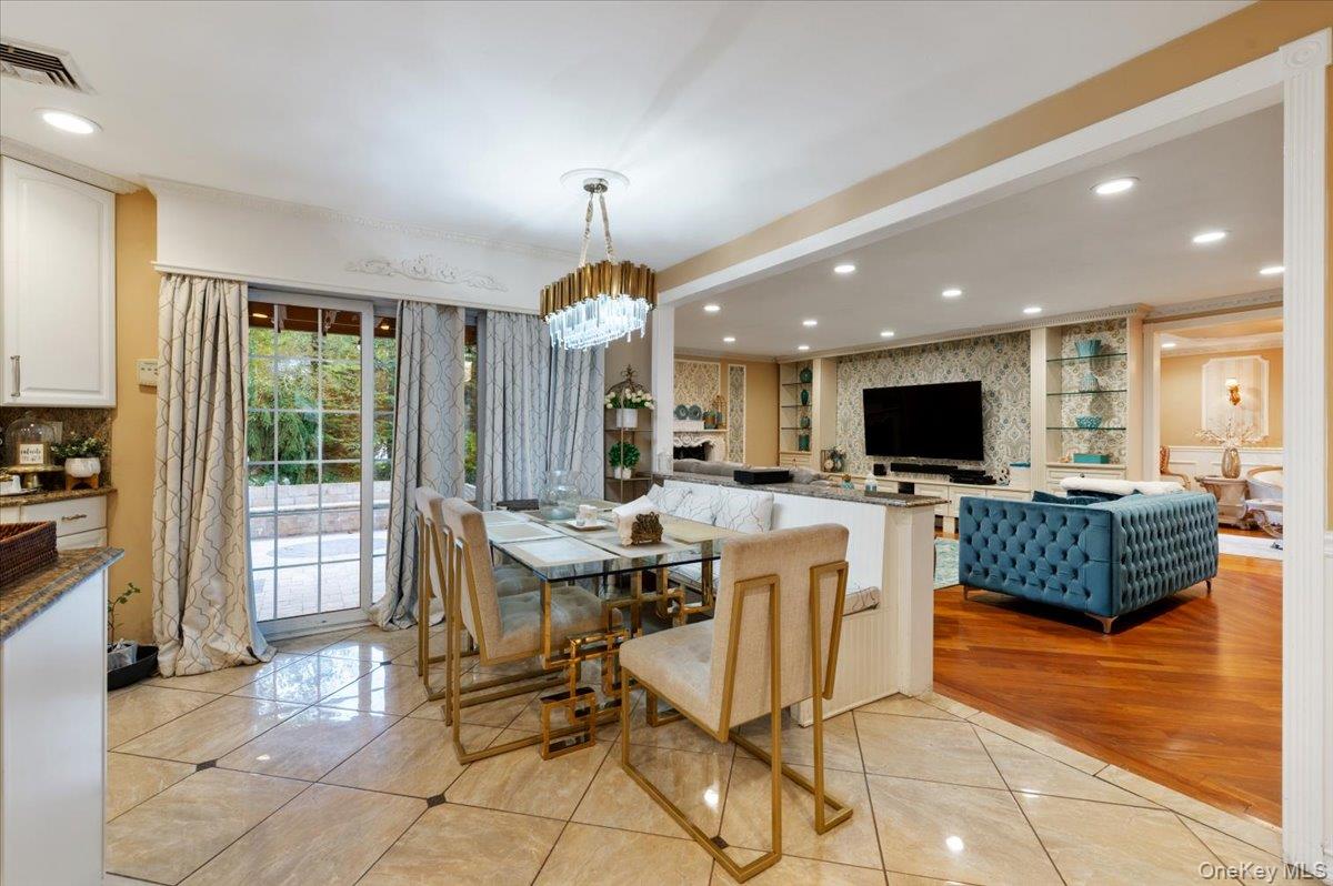 626 Caledonia Road Dix Hills, NY 11746 - Photo 15 of 50 Dining room with recessed lighting, built in features, light tile patterned flooring, and a chandelier