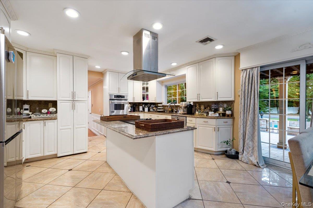 626 Caledonia Road Dix Hills, NY 11746 - Photo 16 of 50 Kitchen with backsplash, dark stone countertops, white cabinetry, light tile patterned flooring, and recessed lighting