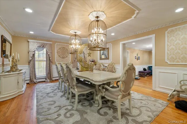 a view of a dining room with furniture and chandelier