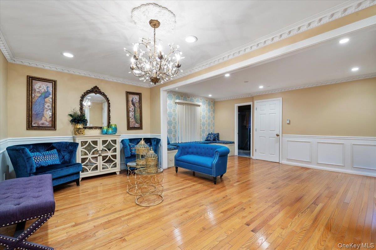 626 Caledonia Road Dix Hills, NY 11746 - Photo 22 of 50 Living area with wainscoting, ornamental molding, light wood-type flooring, a decorative wall, and recessed lighting