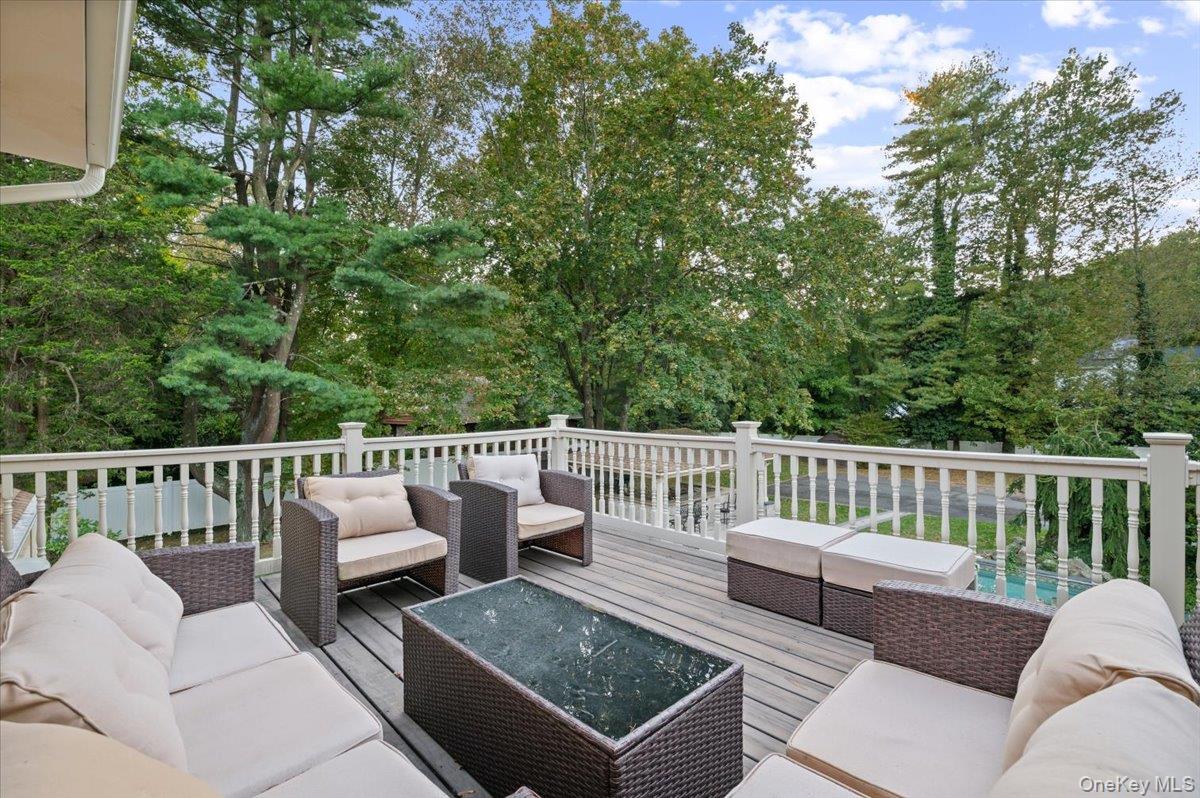 626 Caledonia Road Dix Hills, NY 11746 - Photo 30 of 50 Deck featuring an outdoor hangout area and view of scattered trees