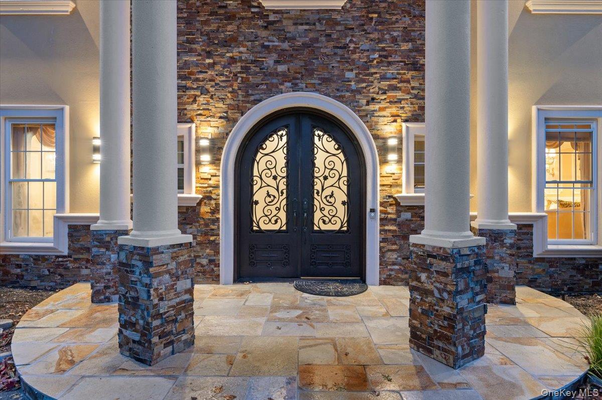 626 Caledonia Road Dix Hills, NY 11746 - Photo 3 of 50 Doorway to property featuring stone siding and stucco siding