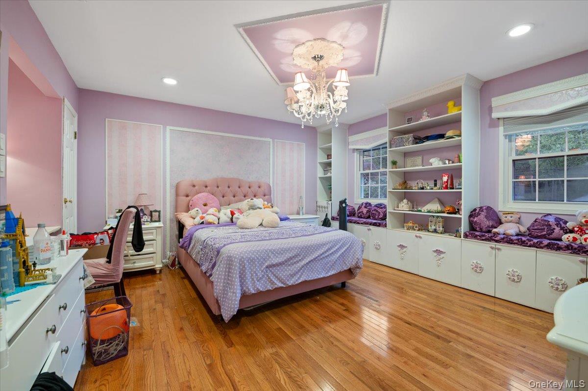 626 Caledonia Road Dix Hills, NY 11746 - Photo 31 of 50 Bedroom featuring light wood finished floors, a chandelier, and recessed lighting