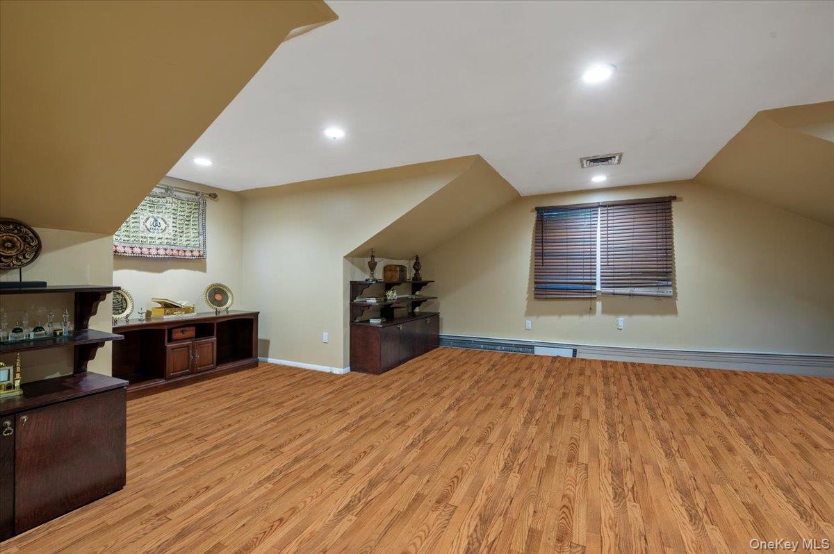 626 Caledonia Road Dix Hills, NY 11746 - Photo 34 of 50 Bonus room with light wood-type flooring, recessed lighting, and vaulted ceiling