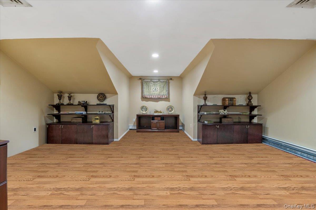 626 Caledonia Road Dix Hills, NY 11746 - Photo 35 of 50 Bonus room featuring light wood-style floors, recessed lighting, and lofted ceiling