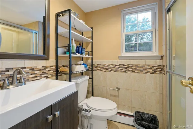 a bathroom with a sink a toilet and mirror