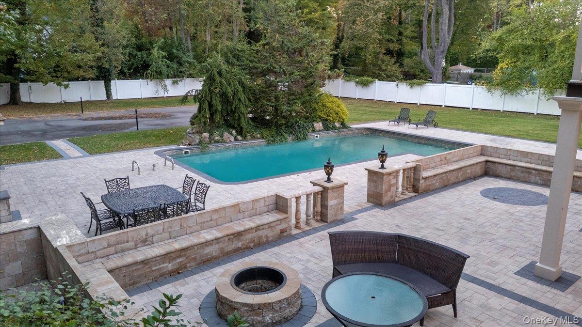626 Caledonia Road Dix Hills, NY 11746 - Photo 39 of 50 View of pool with a patio area and an outdoor fire pit