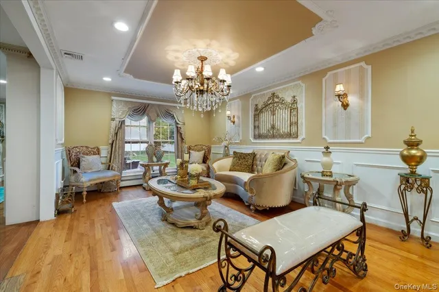 a living room with furniture and a chandelier