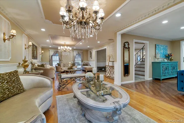 a large living room with dining table and wooden floor