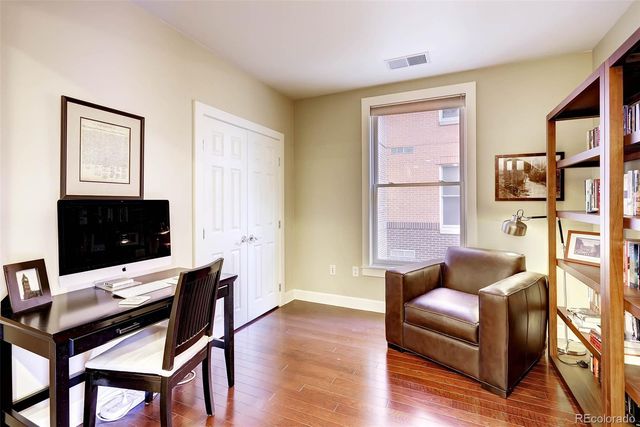 a living room with furniture a flat screen tv and a window