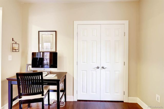 a view of a room with a wooden table and chairs