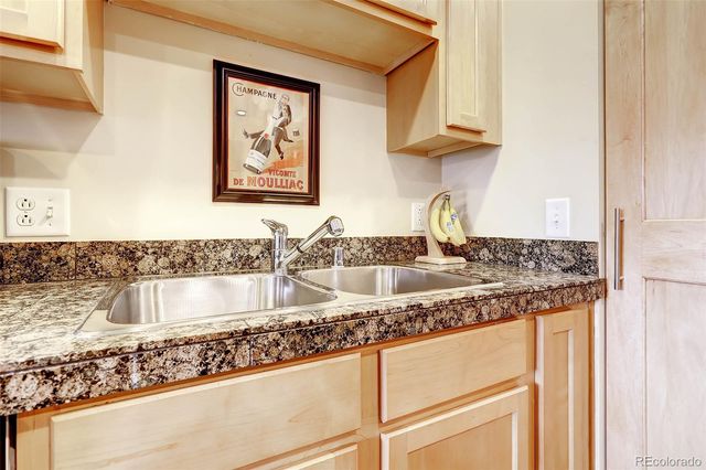 a kitchen with granite countertop a sink and a stove top oven
