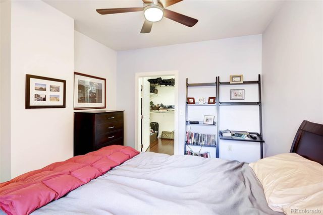 a bedroom with bed and cabinets