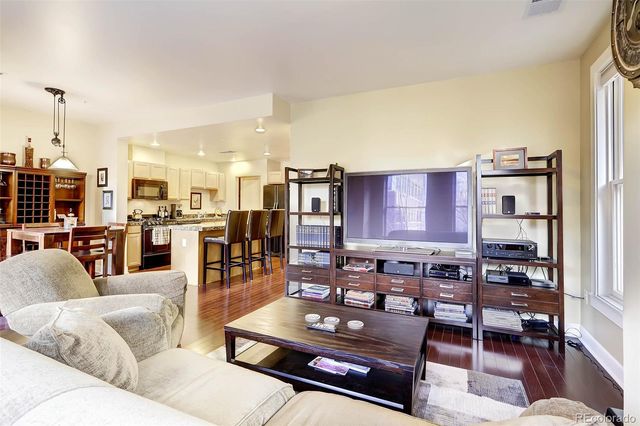 a living room with furniture kitchen view and a table