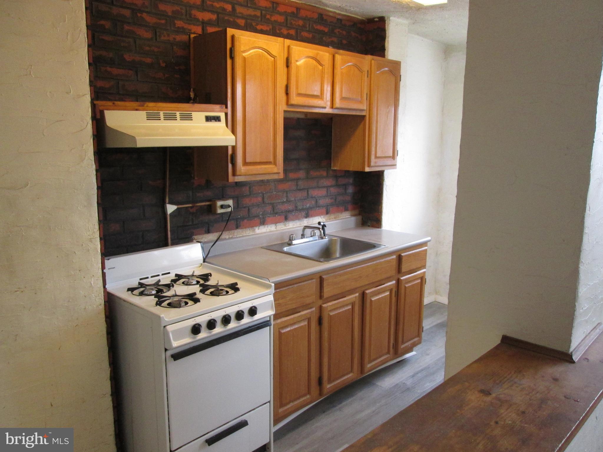 644 Copley Road Upper Darby, PA 19082 - Photo 15 of 47 a kitchen with stainless steel appliances a stove a sink and a microwave