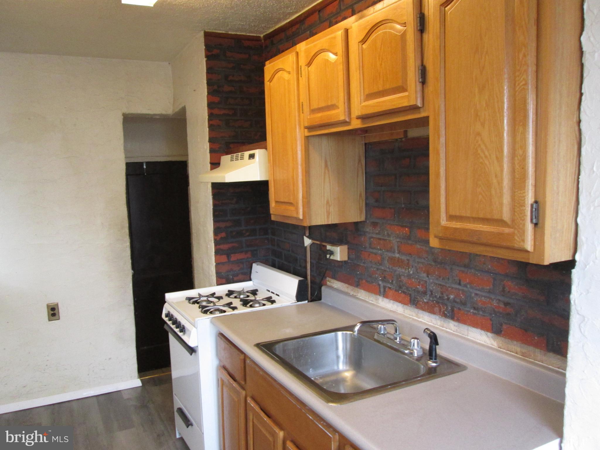 644 Copley Road Upper Darby, PA 19082 - Photo 16 of 47 a kitchen with a sink stove and refrigerator