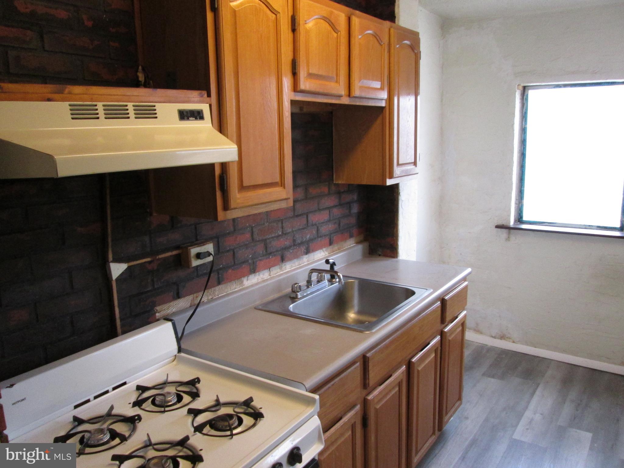 644 Copley Road Upper Darby, PA 19082 - Photo 17 of 47 a kitchen with a sink and a stove top oven