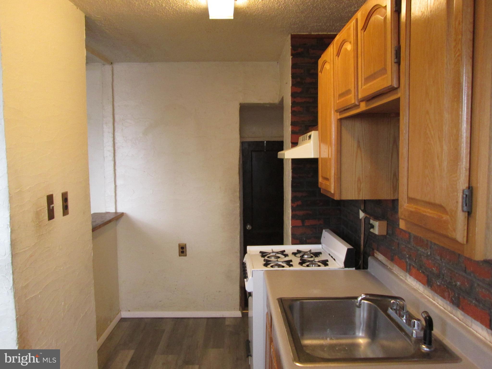 644 Copley Road Upper Darby, PA 19082 - Photo 18 of 47 a kitchen with a sink and a refrigerator