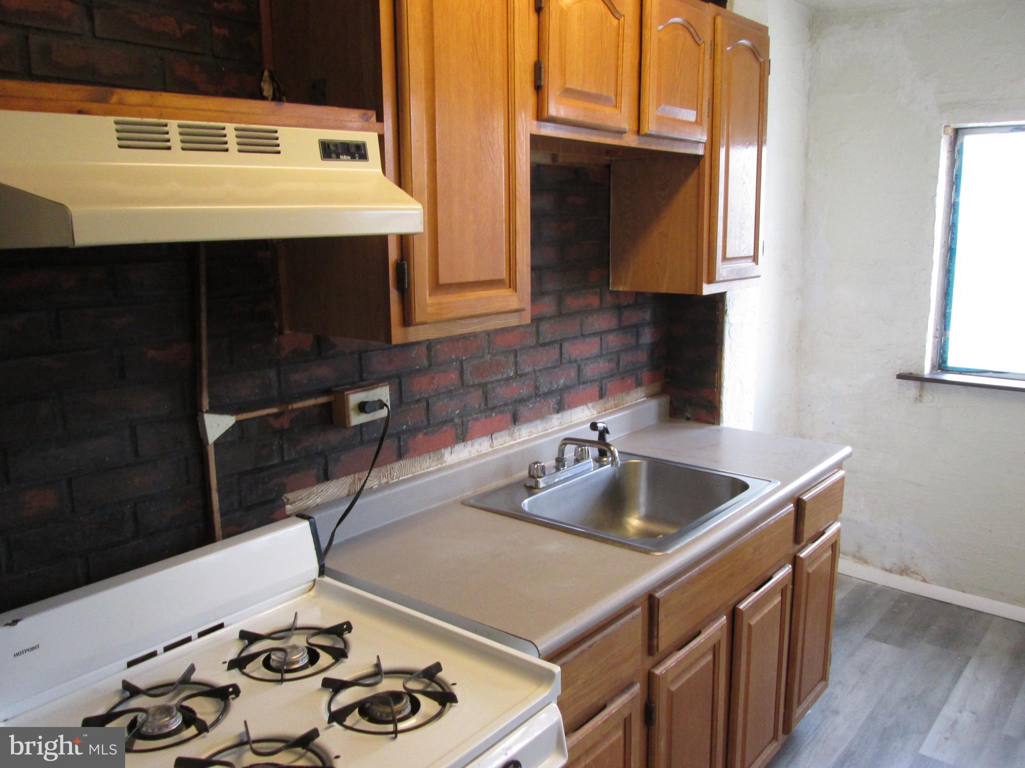 644 Copley Road Upper Darby, PA 19082 - Photo 19 of 47 a kitchen with a sink and a stove