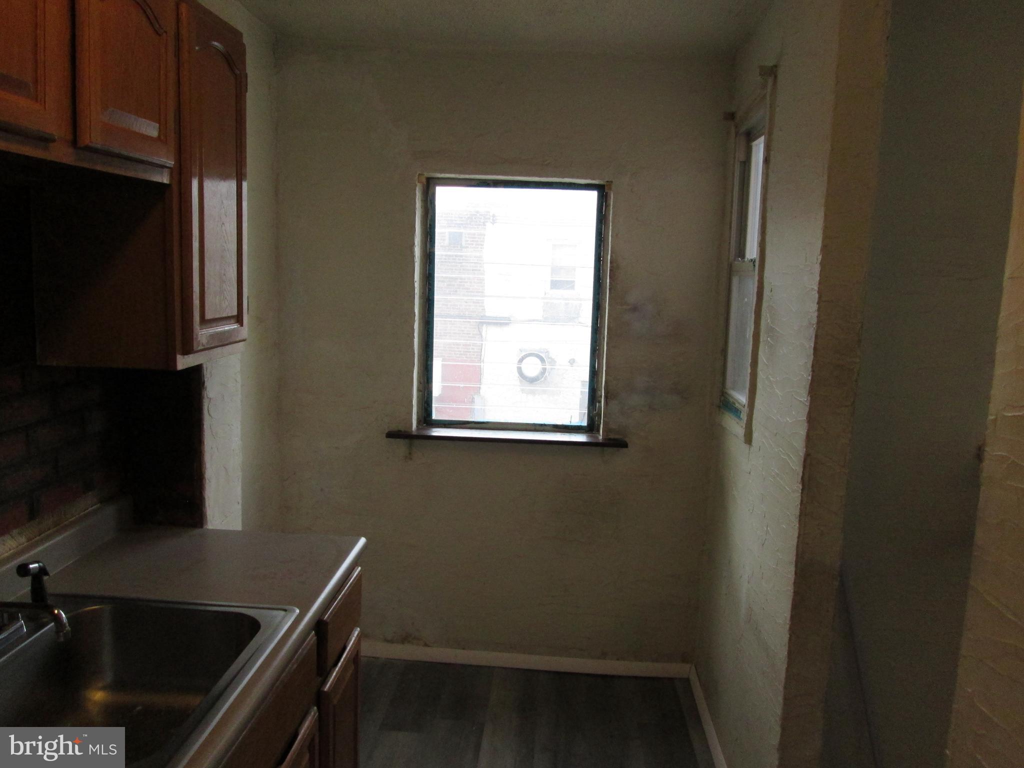 644 Copley Road Upper Darby, PA 19082 - Photo 22 of 47 a view of a bathroom with a sink and a window