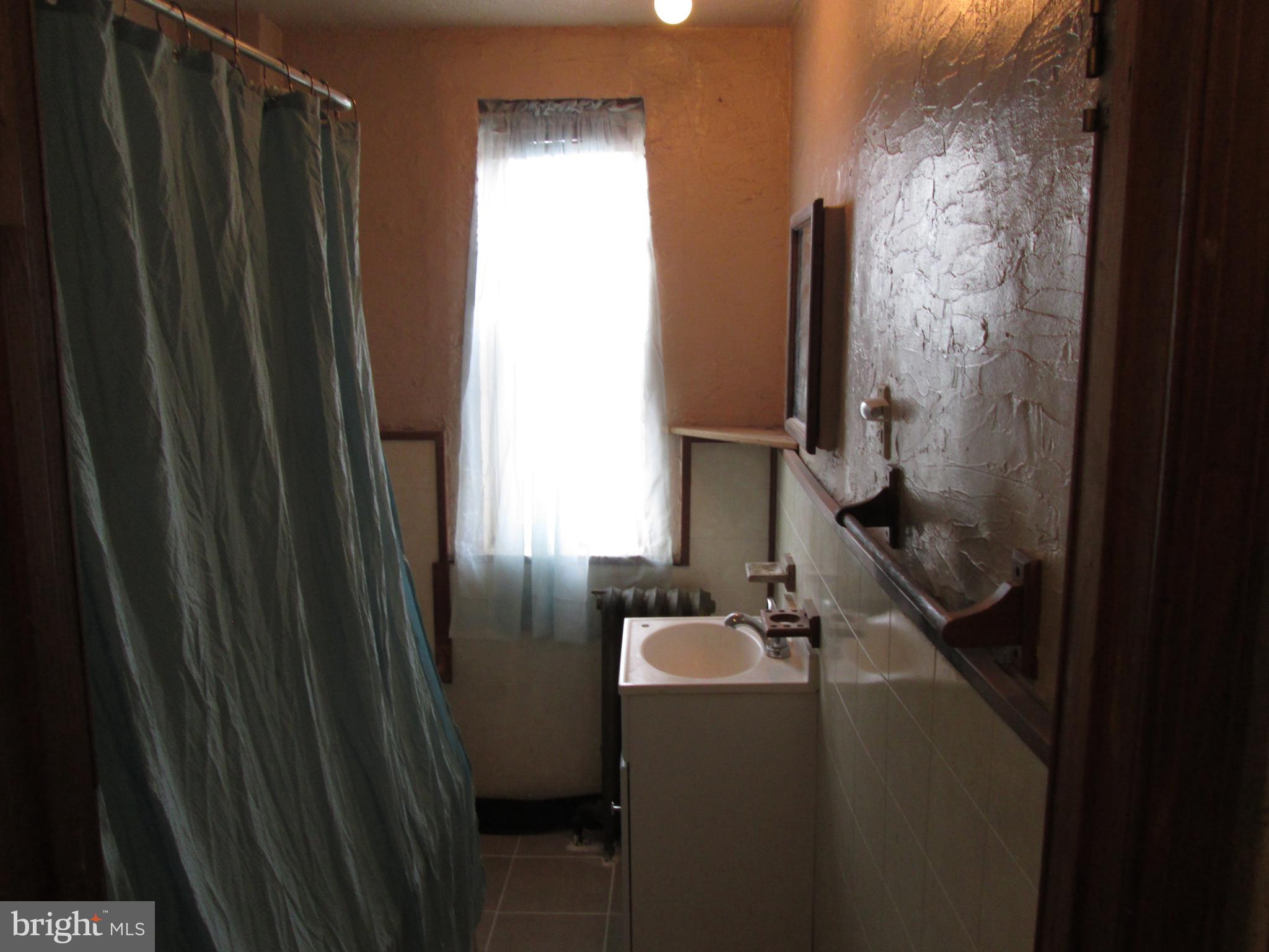 644 Copley Road Upper Darby, PA 19082 - Photo 42 of 47 a bathroom with a sink a mirror and shower