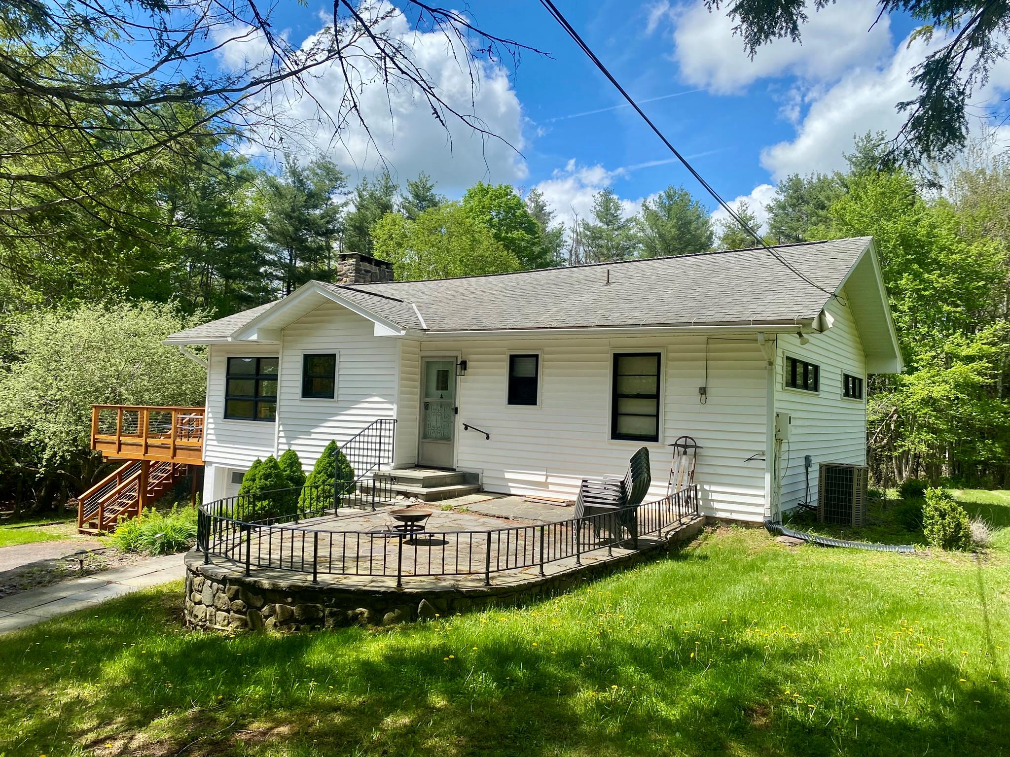 a view of a house with backyard and sitting area