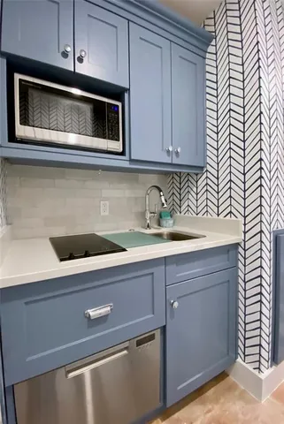 a kitchen with appliances cabinets and a microwave oven