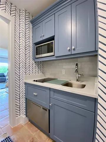 a kitchen with stainless steel appliances granite countertop white cabinets a sink and dishwasher