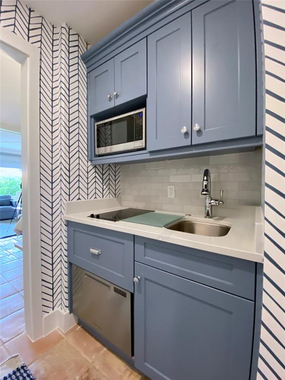 400 Beach Road, Unit 150 Vero Beach, FL 32963 - Photo 12 of 21 a kitchen with stainless steel appliances granite countertop white cabinets a sink and dishwasher