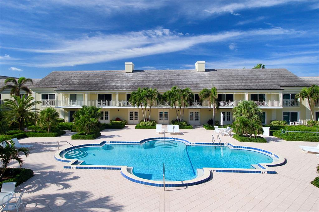 400 Beach Road, Unit 150 Vero Beach, FL 32963 - Photo 20 of 21 a view of a house with pool and chairs