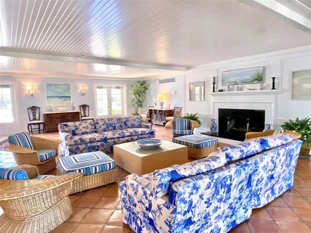 a living room with furniture a fireplace and a table