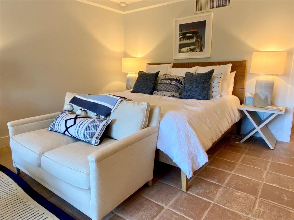 400 Beach Road, Unit 150 Vero Beach, FL 32963 - Photo 10 of 21 a bedroom with a bed and a potted plant on the dresser