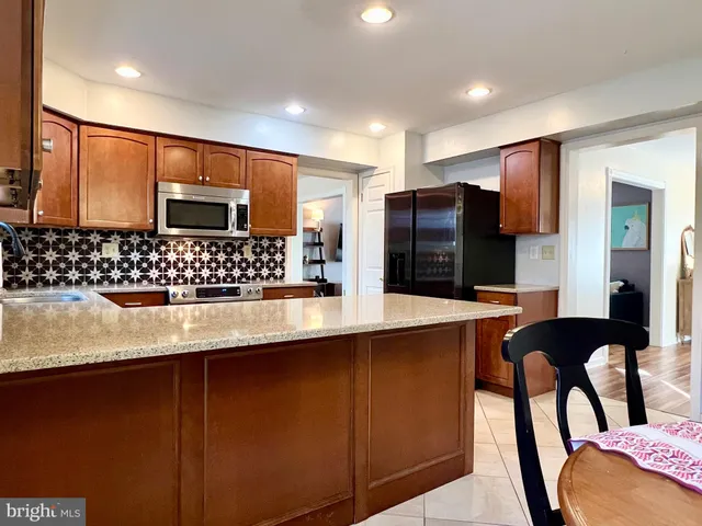 a kitchen with stainless steel appliances a sink and a refrigerator