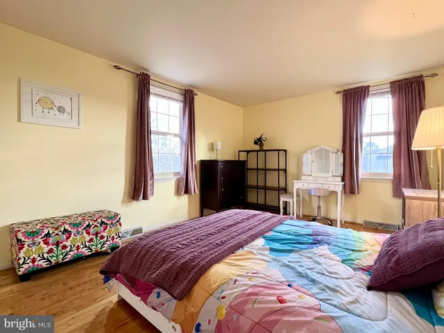 a bedroom with a bed dresser and a window