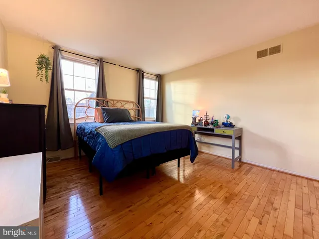 a bedroom with a bed table and a window