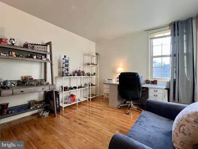 a bedroom with furniture and a wooden floor