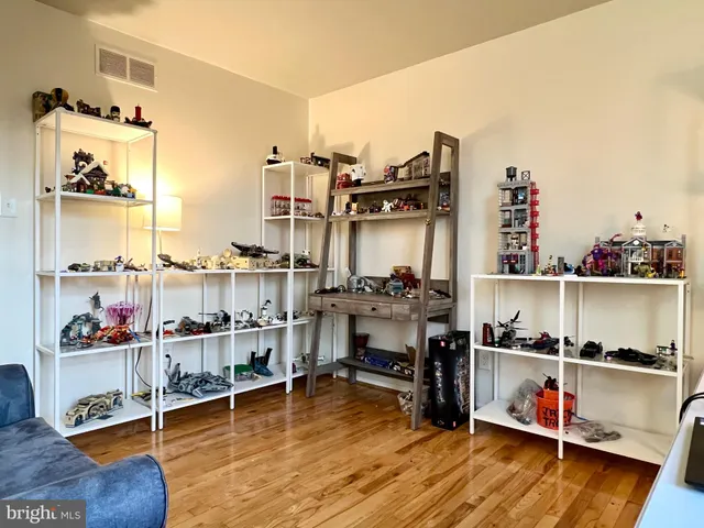 a living room with lots of furniture and a wooden floor