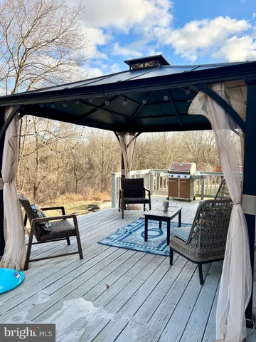 a view of deck with chairs and wooden floor